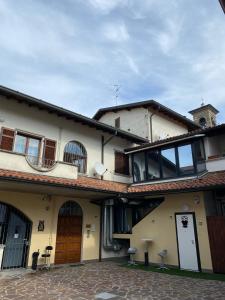 ein großes weißes Gebäude mit Balkon darüber in der Unterkunft Il Caravaggio Guest House in Grassobbio