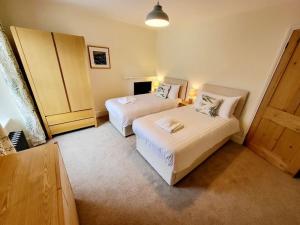 a hotel room with two beds and a window at 8 Duke Street - Launceston Cornwall in Launceston