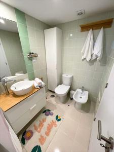 a bathroom with a sink and a toilet at Casa da Boa Gente in Cabanas de Tavira