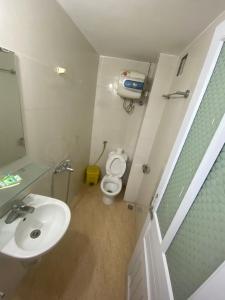 a small bathroom with a sink and a toilet at Hoàng Kiên Hotel in Hanoi