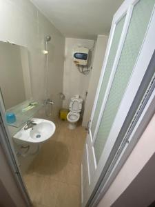 a bathroom with a sink and a toilet at Hoàng Kiên Hotel in Hanoi