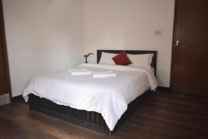 Rúm í herbergi á Cocina Mitho Chha BNB