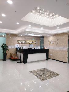 a hotel lobby with a hotel sign on the wall at Hotel STAYON in Geoje 