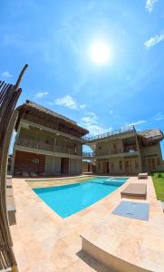 a villa with a swimming pool in front of a building at Casa Mambo Salinas in Santa Veronica
