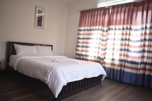 Rúm í herbergi á Cocina Mitho Chha BNB