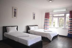 Rúm í herbergi á Cocina Mitho Chha BNB