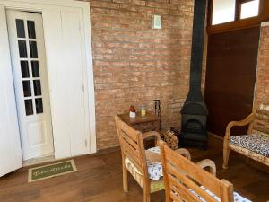a room with a brick wall and a wood stove at Chamonix Chales - OAK Plaza in Monte Verde