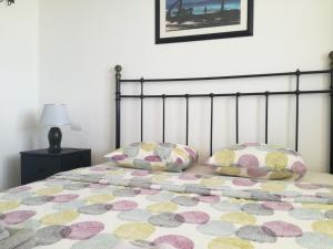 a bedroom with a bed with two pillows on it at Two bedroom apartment 2 min from beach in Mogán