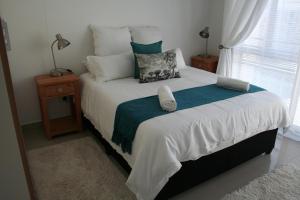 a bedroom with a large bed with a window at The Quadrant, G505 in Cape Town