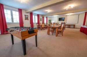 a conference room with a table and a board at Penzion Josu in Zuberec