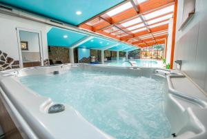 a large hot tub in a room with at Penzion Josu in Zuberec