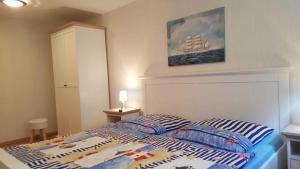 a bedroom with a bed with two pillows on it at Ferienunterkuenfte Buggenthin in Zinnowitz +21 photos