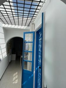 a blue door in a room with a ceiling at Chez ADAC in Sidi Bou Saïd