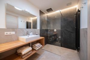 a bathroom with a sink and a shower at Villa Ca' Stella Lake Garda in Brenzone sul Garda +76 photos