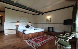 ein Schlafzimmer mit einem Bett und einem Stuhl in einem Zimmer in der Unterkunft The Nettle and Fern Farmstay in Pelling