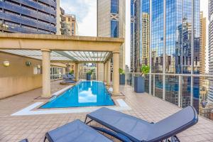 a patio with a swimming pool and two chairs at CBD Corporate Apartment BON002810 in Sydney