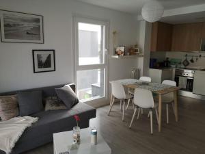 a living room with a couch and a table with chairs at Casa de Olga & Jorge in Luanco