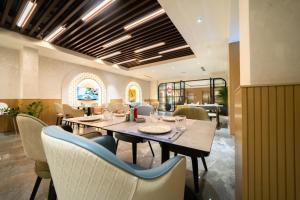 a dining room with a table and chairs at Millennium Place Mirdif in Dubai