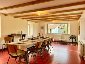 COC - Villa La Finca في Audembert: غرفة طعام كبيرة مع طاولة وكراسي طويلة