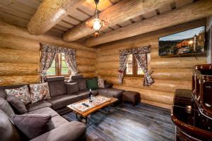 a living room with a couch and a table at Chatky JOSU in Zuberec