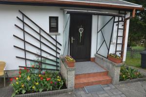 a front door of a house with flowers at Ferienhaus Harztraum in Sorge