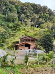 a house on the side of a hill at Casa de campo Blumenau, 21km da vila germânica in Blumenau