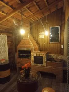 a room with a fireplace in a wooden house at Nossacasa-de-campo in Blumenau