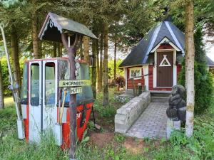 a toy train and a small house in a yard at Ferienwohnung "Haus Sonnenblick" in Trautenstein