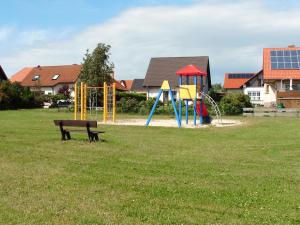 a park with a bench and a playground at Ferienwohnung Nichau in Hasselfelde