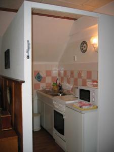 a kitchen with a sink and a stove at Ferienwohnung Lippe in Elbingerode