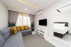 a living room with a couch and a bed at Modern and Central Flat near Beach in Muratpasa in Antalya