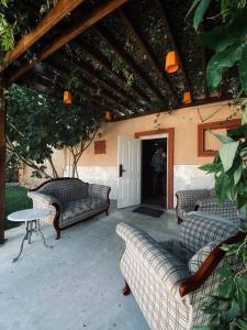 a patio with couches and a table and a door at CAMP&HOSTEL Antalya in Antalya