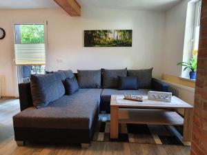a living room with a couch and a coffee table at Haus Sonja in Tanne