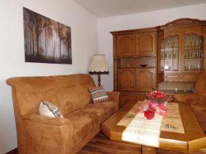 a living room with a couch and a coffee table at Harzhaus Sorge in Sorge