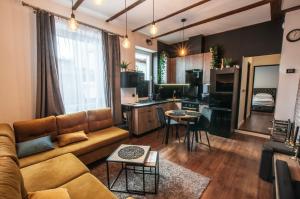 a living room with a couch and a kitchen at Dworcowa Centrum Apartament in Bydgoszcz