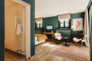 1 dormitorio con paredes verdes, 1 cama y escritorio en Auberge du Pêcheur, en Sint-Martens-Latem