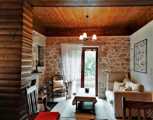 a living room with a couch and a fireplace at Stonehouse dome Lagadia in Lagkadia