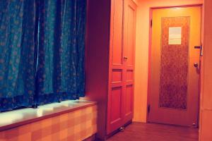um quarto com uma porta, uma janela e uma cortina em Li Duo Hotel em Tainan