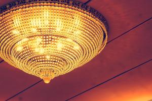 a large yellow chandelier hanging from a ceiling at Li Duo Hotel in Tainan