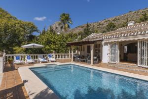 a swimming pool in front of a house at Villa Levante in Jávea