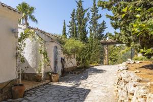 an alleyway leading to a building with a gate at Villa Levante in Jávea