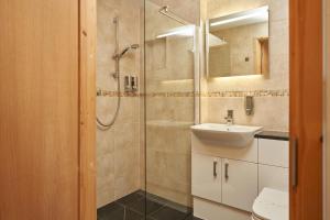 a bathroom with a shower and a sink and a toilet at The Windmill Inn in Watchet