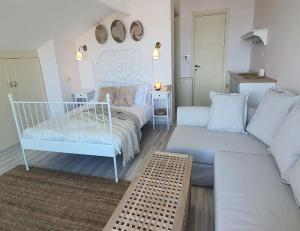 a living room with a bed and a couch at Fİ SALDA in Doğanbaba