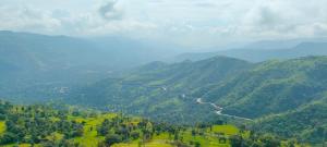 a view of a valley of mountains with a river at Konark Villa in Mahabaleshwar