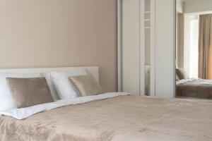 a bedroom with a large bed with a mirror at RentWill apartments Milky Way in Chişinău