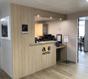 an office with a ape hotel sign on a wall at Ace Hotel Issoire in Issoire