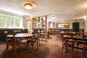 a dining room with wooden tables and chairs at The Windmill Inn in Watchet