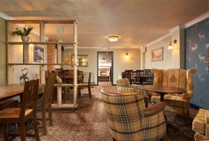 a living room with a table and chairs at The Windmill Inn in Watchet