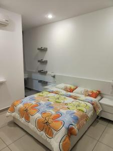 a bedroom with a bed with flowers on it at Prestij 3 Homestay, Balik Pulau in Balik Pulau