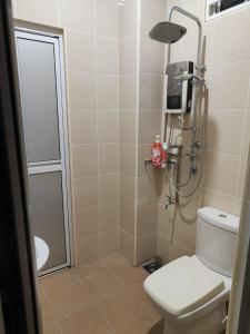 a bathroom with a shower and a toilet in it at Prestij 3 Homestay, Balik Pulau in Balik Pulau